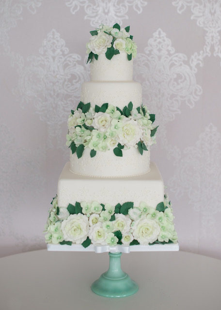 Wedding cake with pastel green flowers 