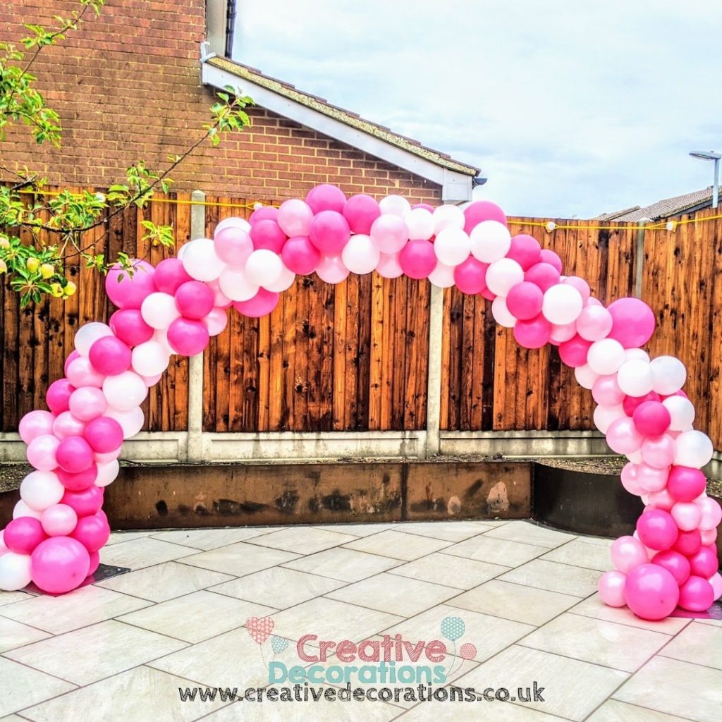 Pink and white balloon arch for garden parties 