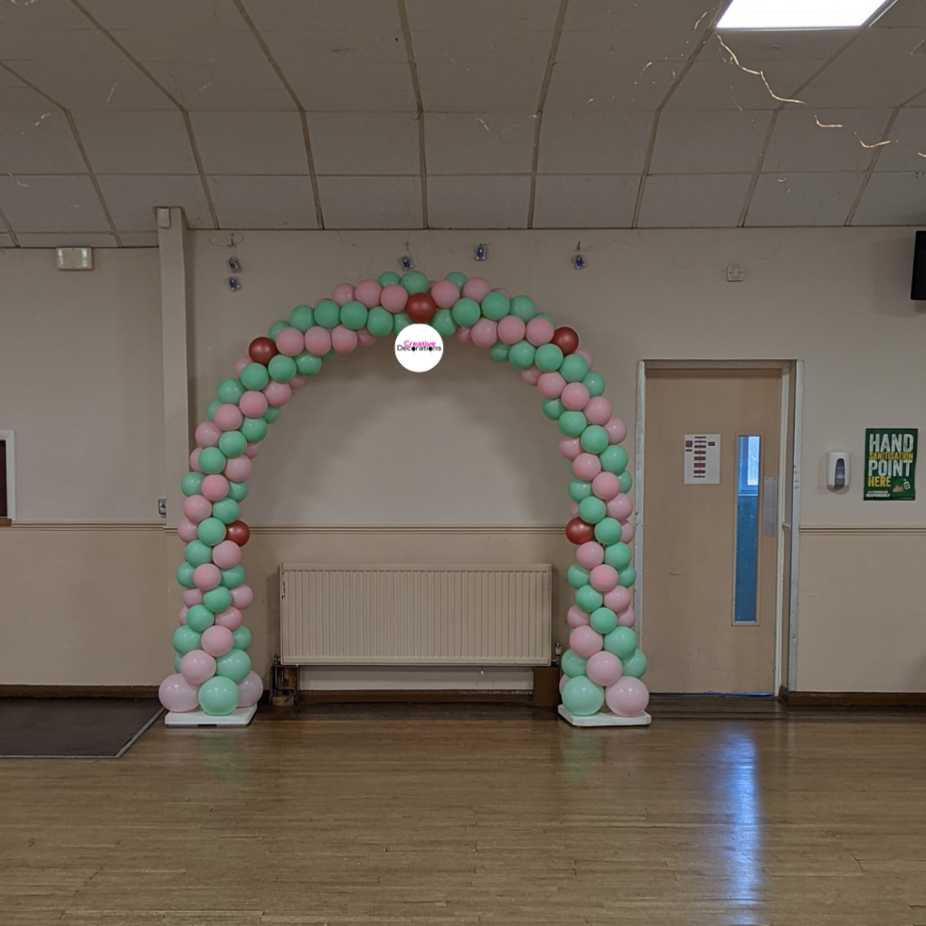 Green and pink balloon arch 