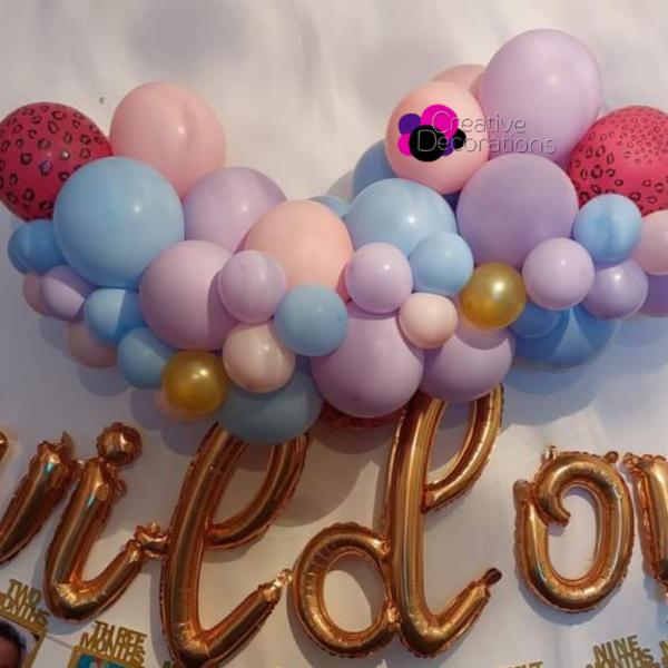 Pastel coloured balloon garland with added hot pink leopard print balloons