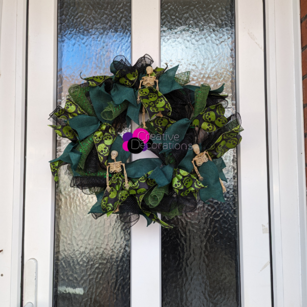 Green and black halloween themed ribbon wreath