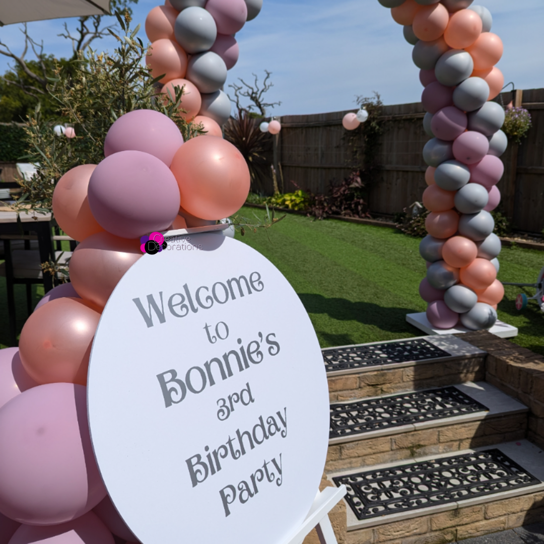 Welcome sign and balloon arch for a kids garden party